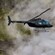 A helicopter flying over the thick smoke of a volcano